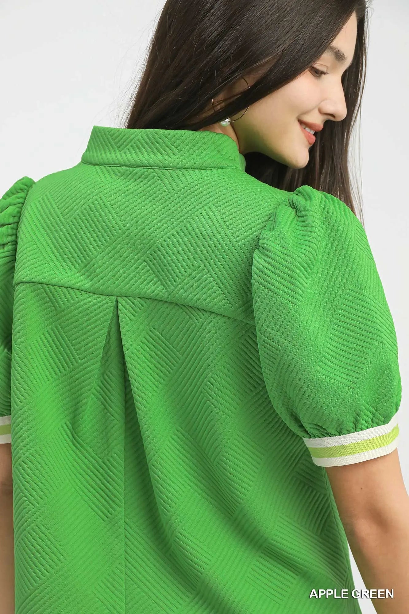 Back view of women’s green puff sleeve top from Waco boutique
