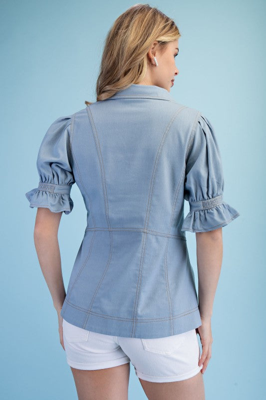 Back view of women’s light denim linen blouse from Waco boutique