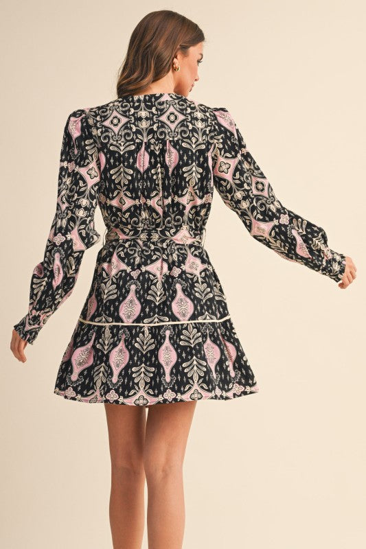 Woman wearing a patterned dress on a beige background