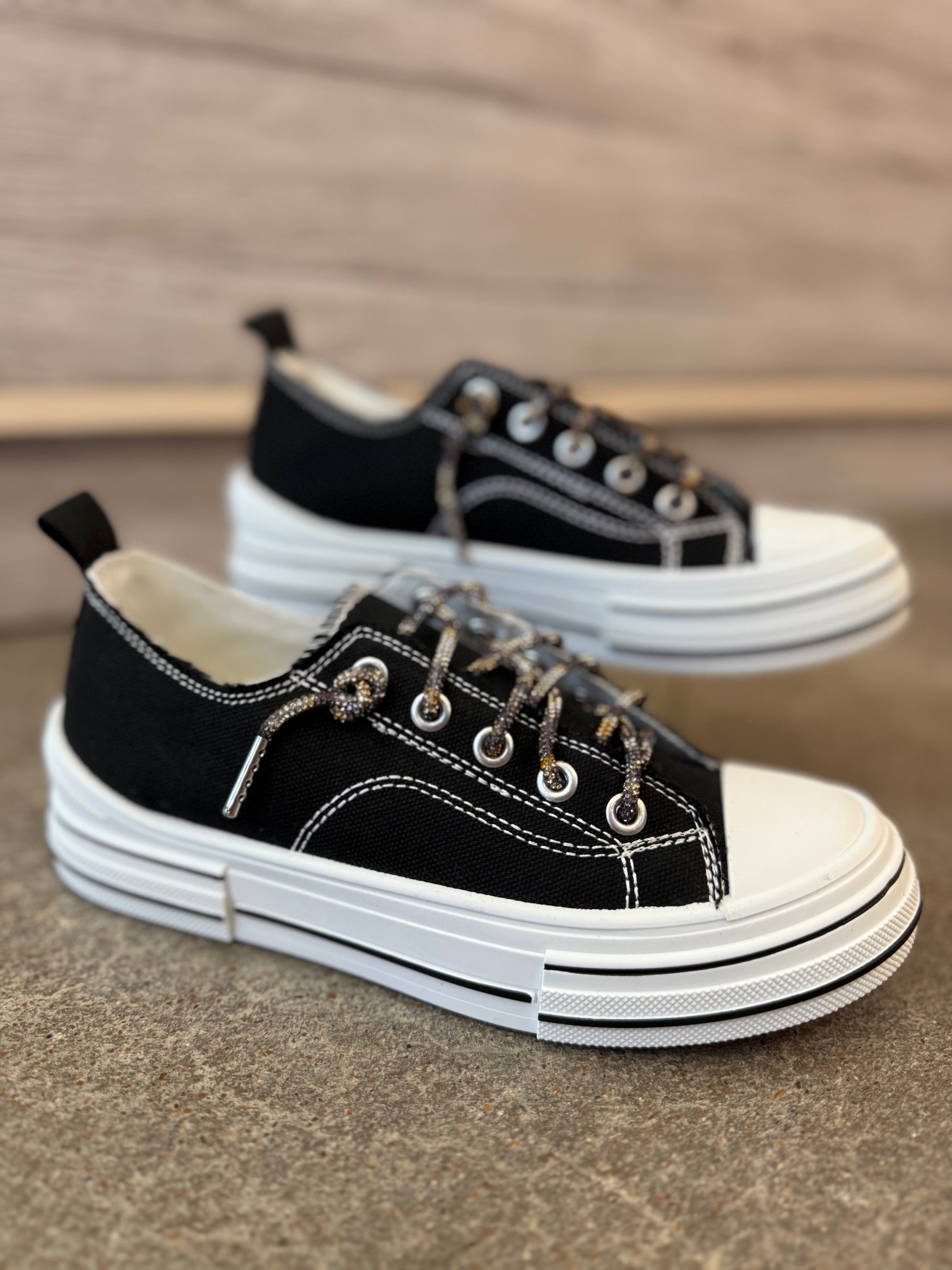 Black and white sneakers on a textured surface