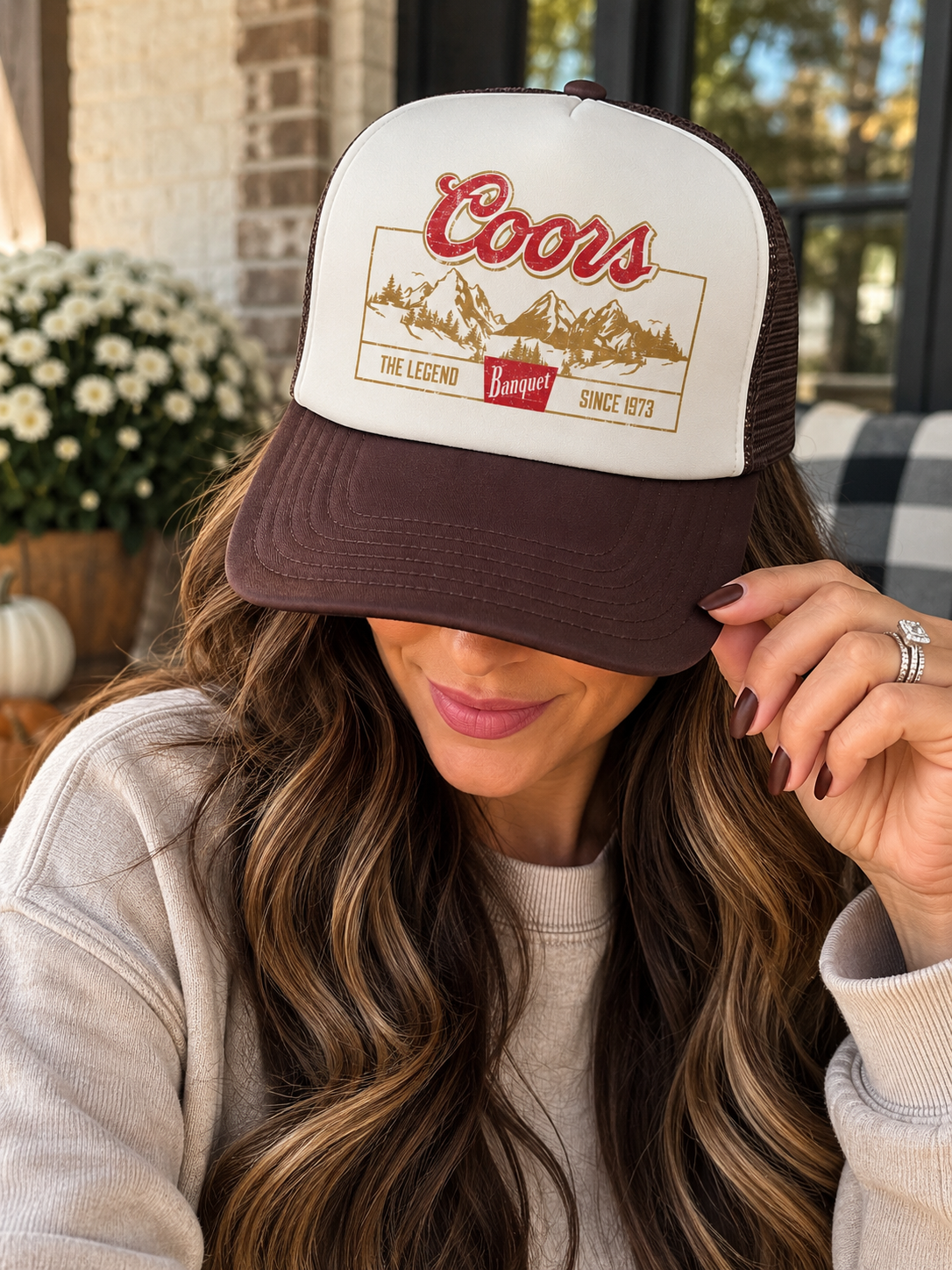 Cream and brown Coors Banquet vintage trucker hat with mountain graphic and mesh back.