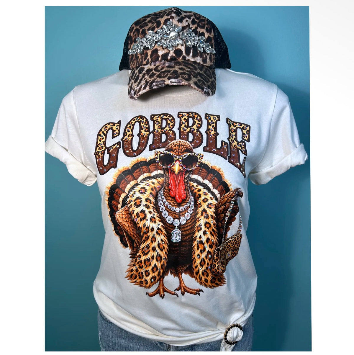 White Thanksgiving graphic tee featuring a glamorous leopard print turkey with sunglasses, jewelry and sparkling AB rhinestone embellishments