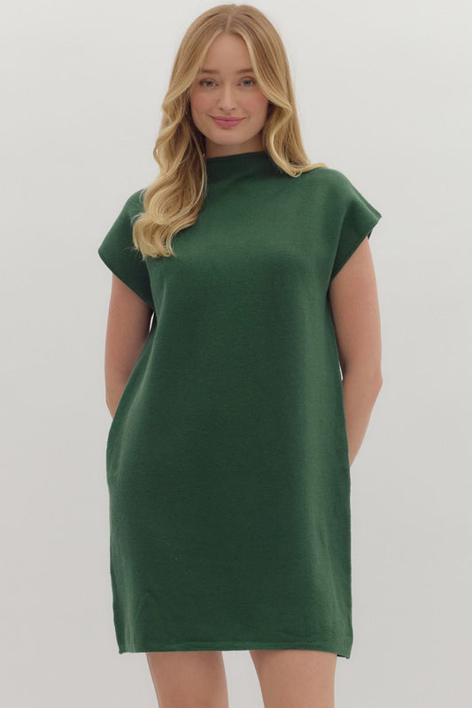 Woman wearing a green dress against a white background