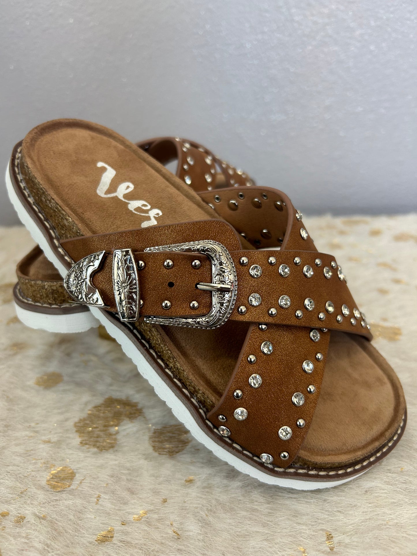 Very G Jocilyn tan slip-on sandals with criss cross straps, buckle accents, and sporty white outsole
