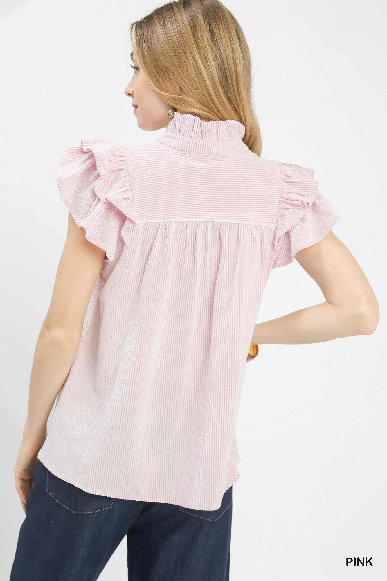 Back view of women’s pink ruffle sleeve blouse from Waco boutique