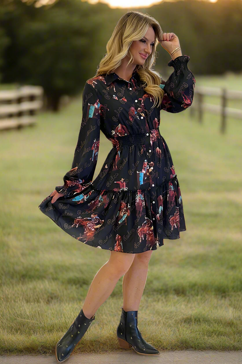 Woman wearing a black western graphic dress with long sleeves.