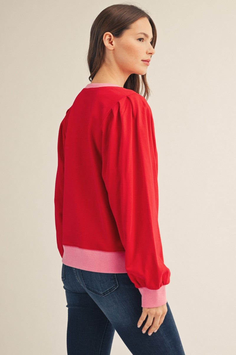 Red and pink women's casual top with notched neckline and puff shoulders