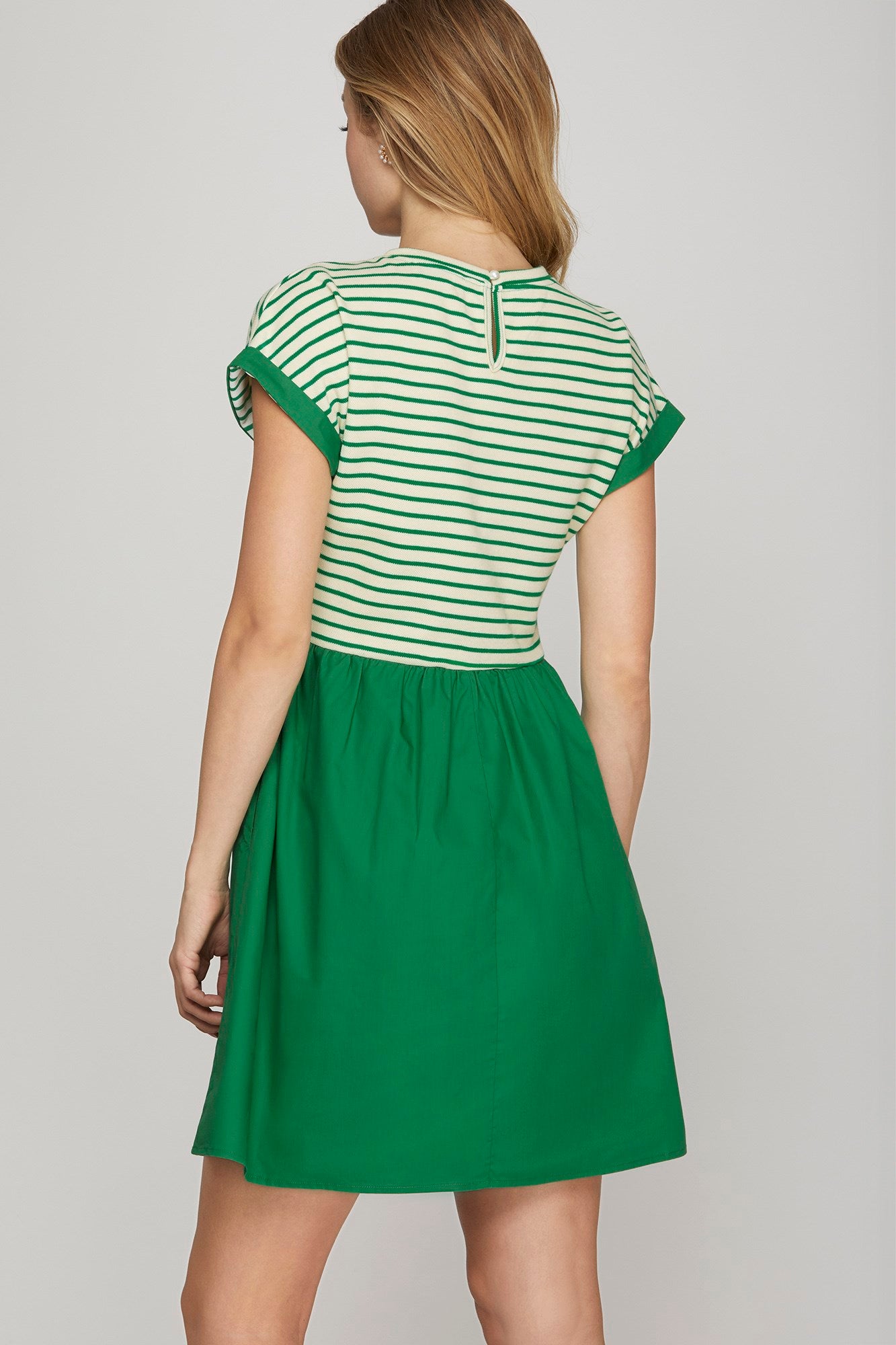 Back view of green knit and woven combo dress