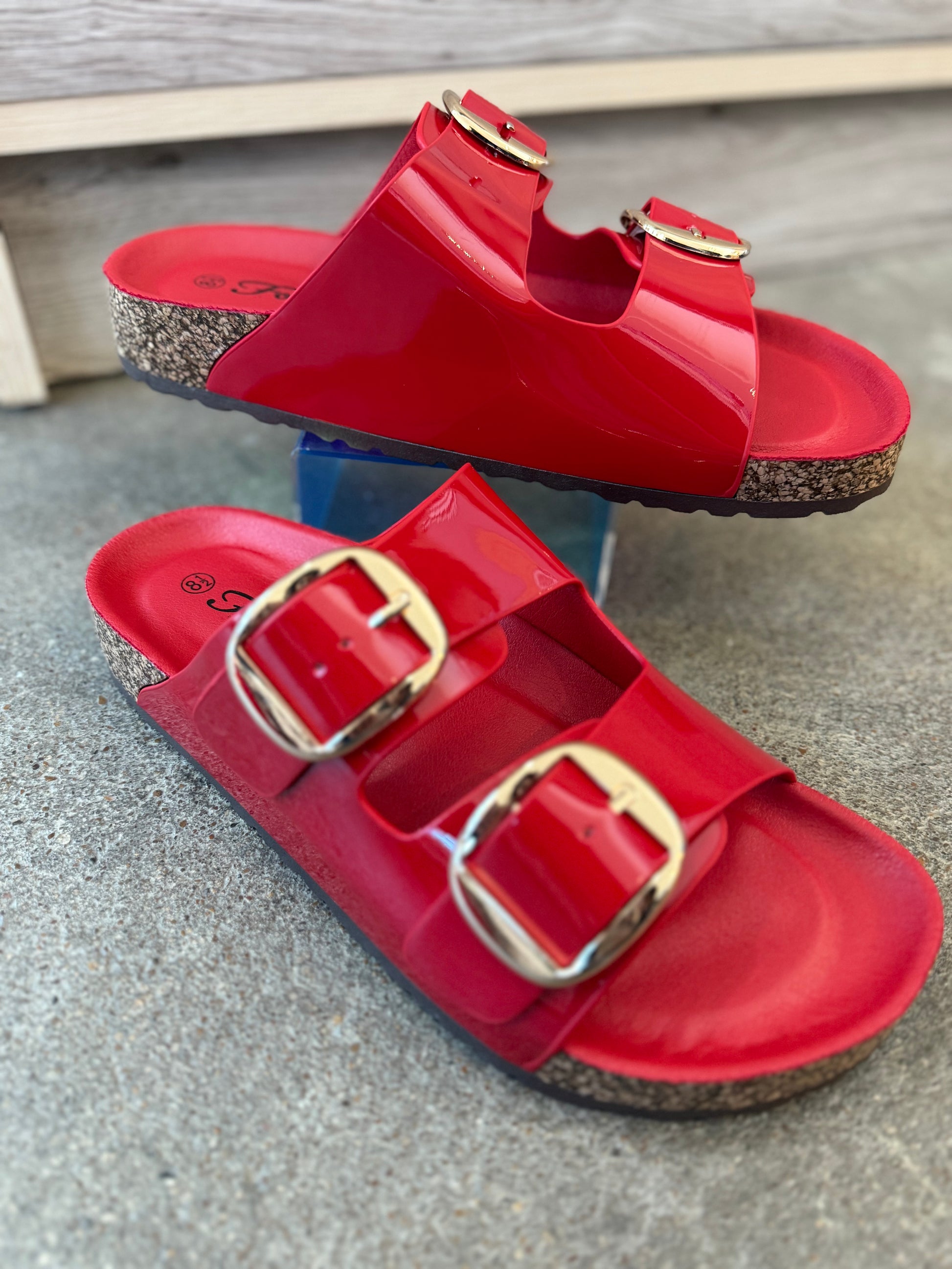 Trendy red double buckle sandals perfect for jeans, dresses, and shorts