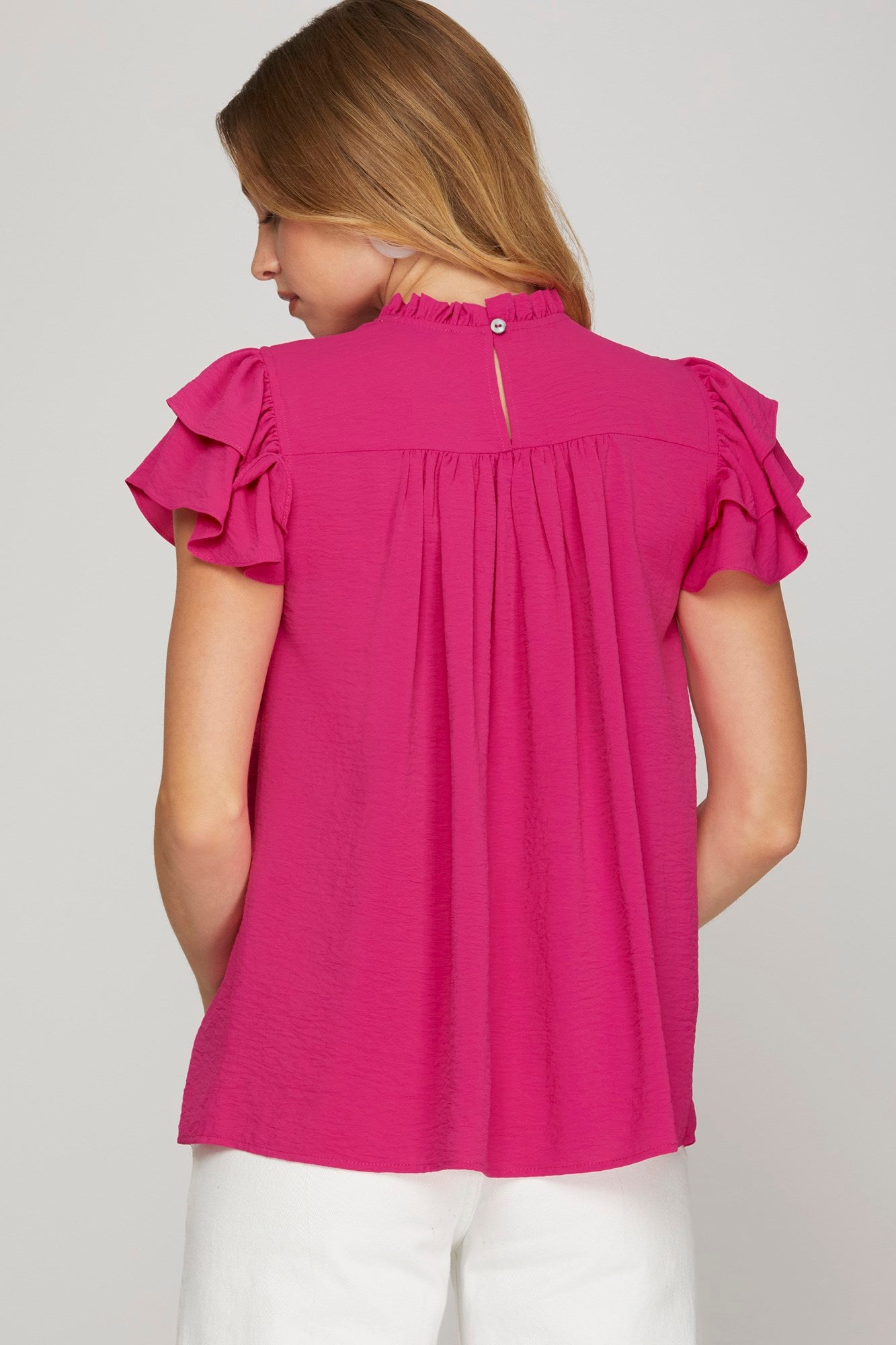Back view of hot pink pleated yoke top