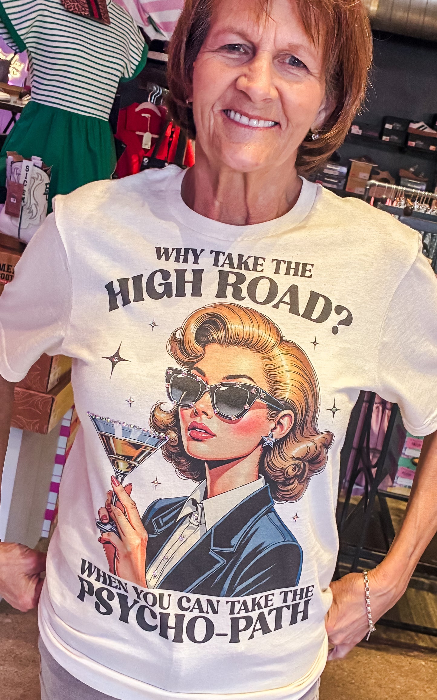 Woman wearing a t-shirt with a graphic design and text in a store setting