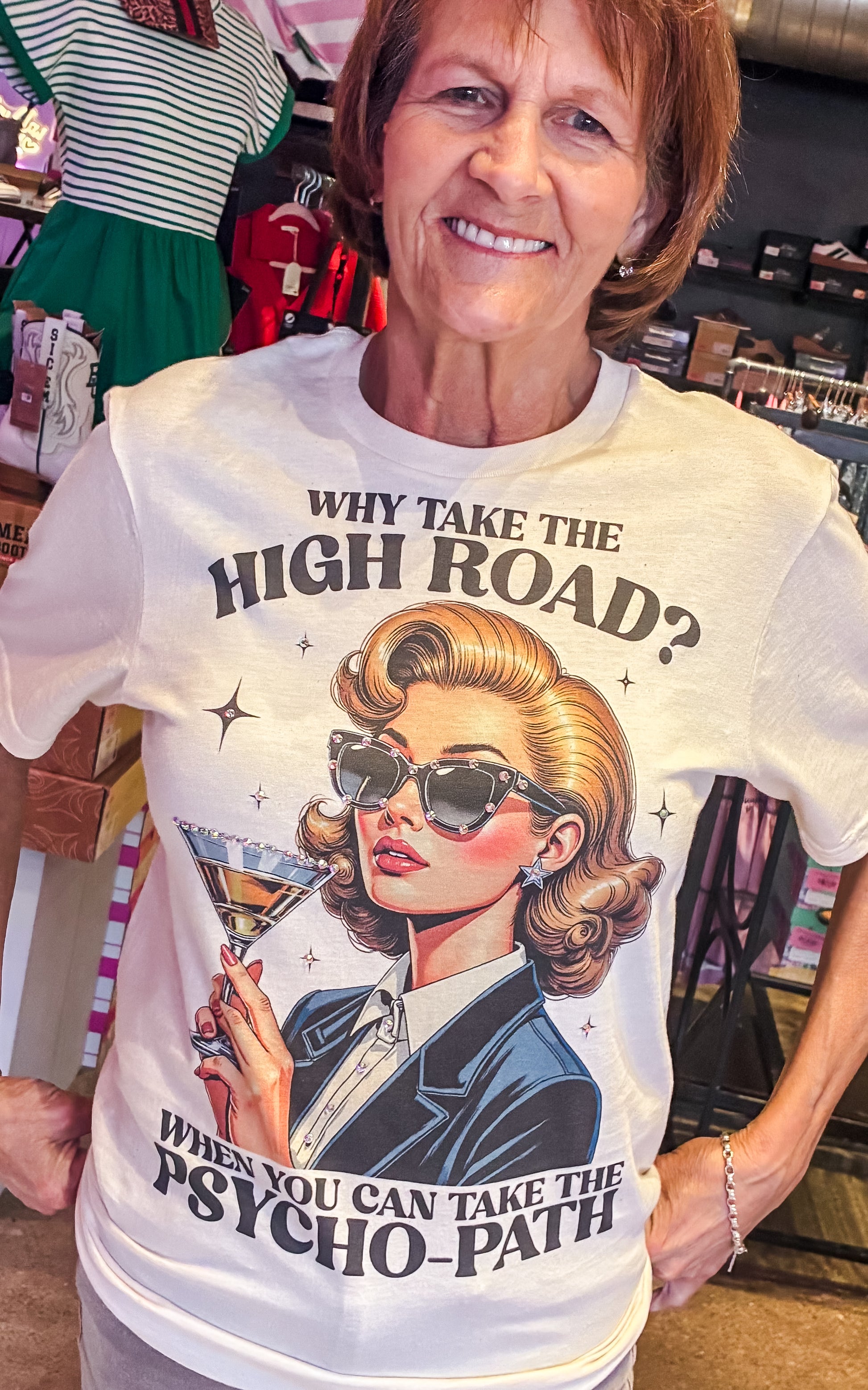 Woman wearing a t-shirt with a graphic design and text in a store setting