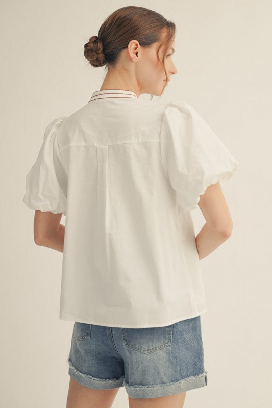 Feminine boutique top with puff sleeves and mock necK