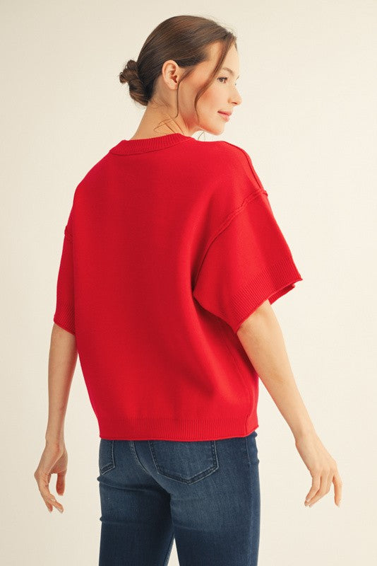 Red drop shoulder sweater top with raw edge detail and relaxed fit.
