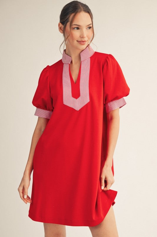 Red puff sleeve shift dress with stripe contrast detail, standing neckline, notched V-neck, and side pockets.

