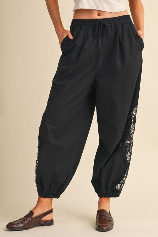     Women’s black balloon pants with sheer floral lace side panels