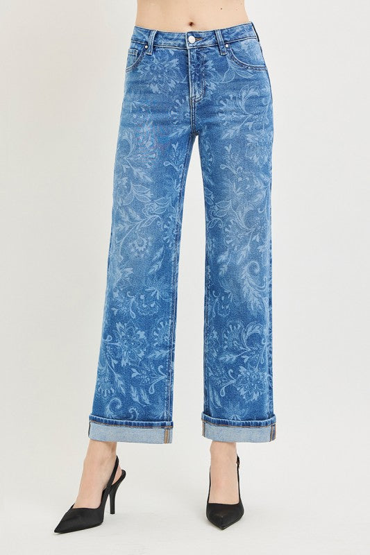 Blue floral-patterned jeans on a white background