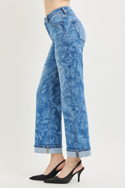 Blue patterned jeans worn by a person on a white background