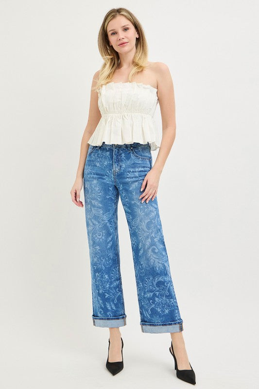Woman wearing blue paisley print mid rise straight leg jeans with cuffed ankle hem and black heels