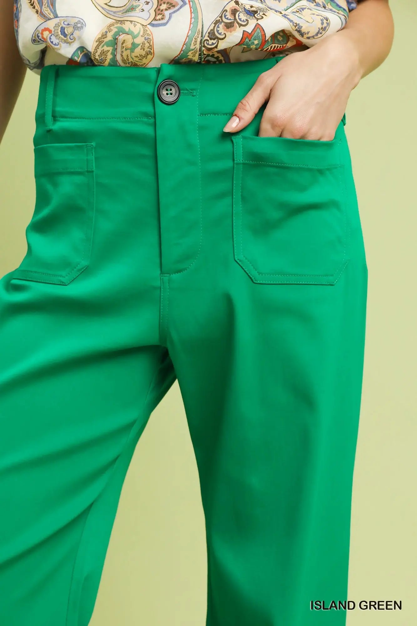 Pocket detail on women’s green button stretch pants boutique Texas
