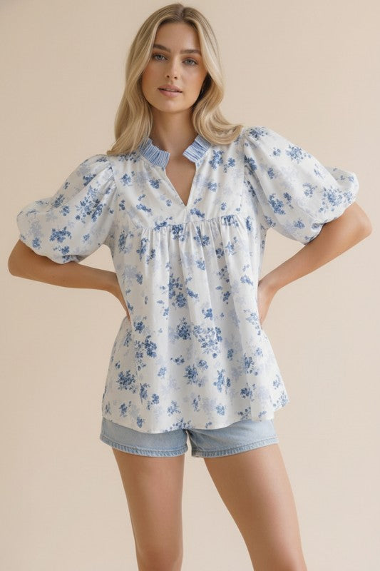 Front view of floral woven blouse with stripe color block yoke