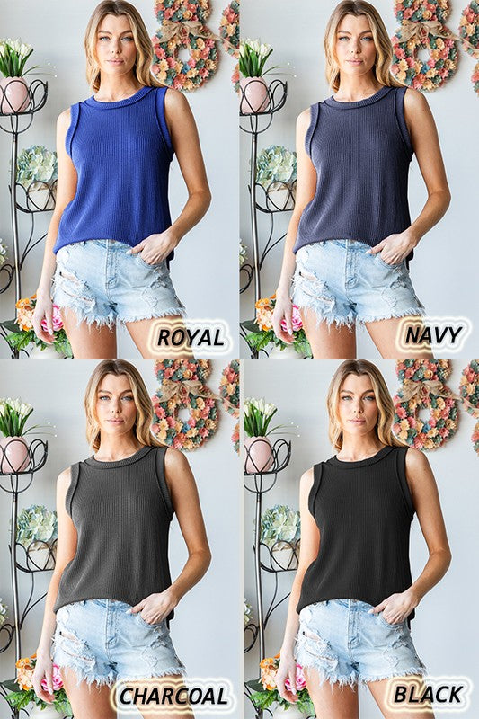 Front view of banded black round neck ribbed knit sleeveless top