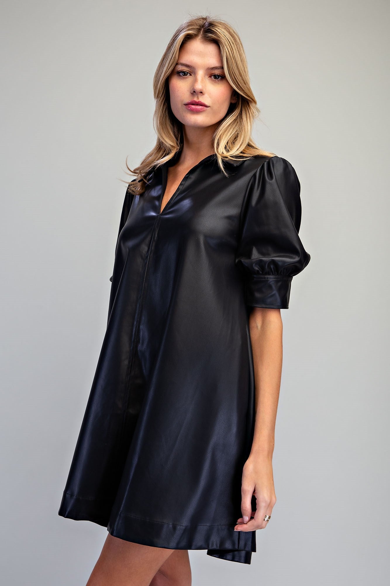 Side detail After Dark black faux leather puff sleeve mini dress with pockets