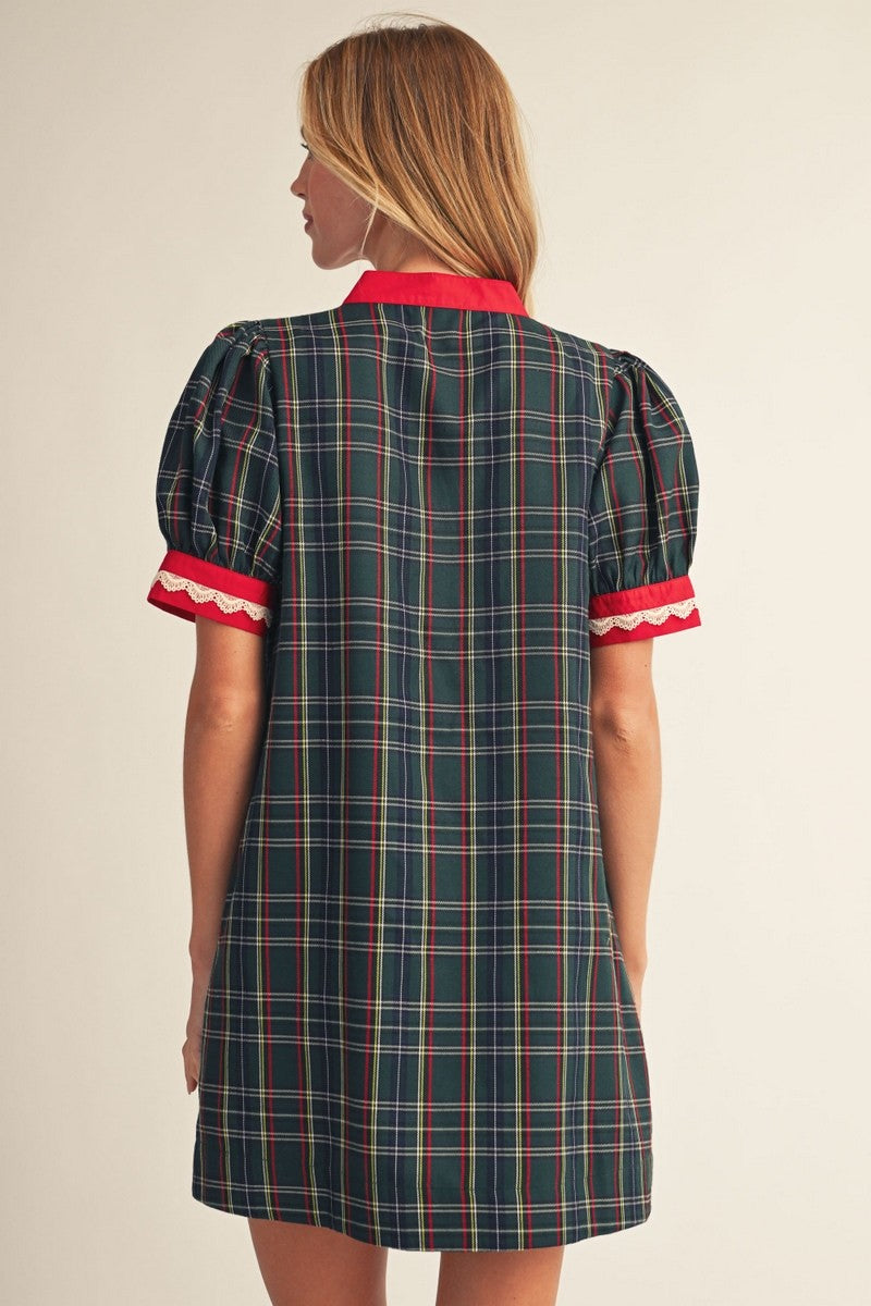 Back view of women's plaid Christmas shift dress with red trim and short puff sleeves