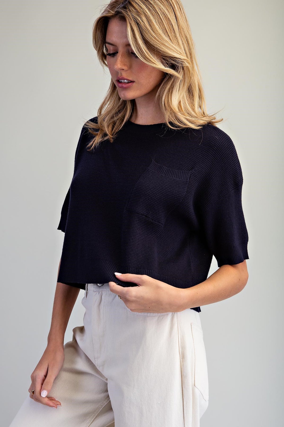 Dark blue waffle knit cropped pocket top with relaxed boxy fit and elbow-length sleeves