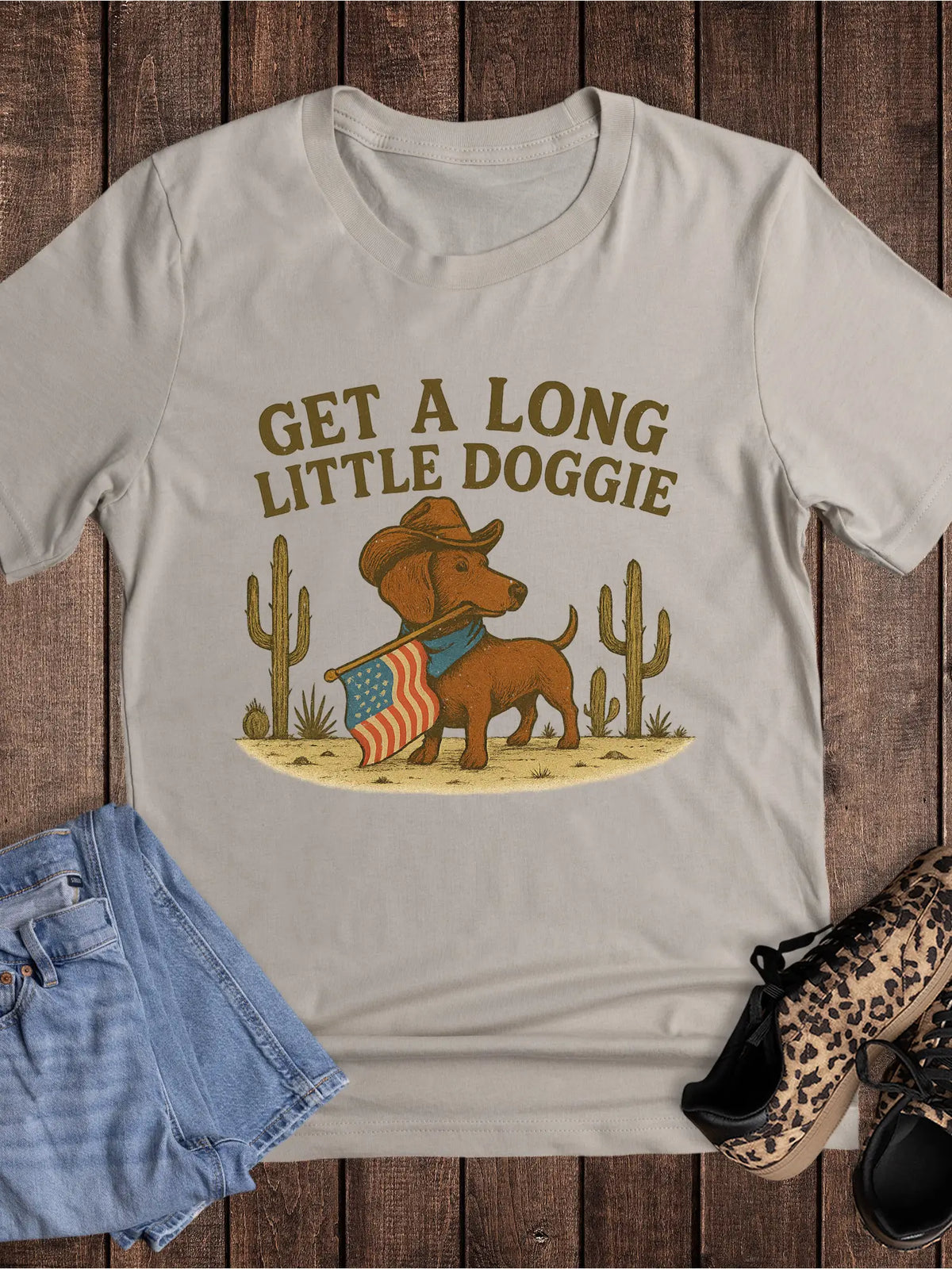 Get A Long Little Doggie western graphic tee with cowboy dachshund and American flag