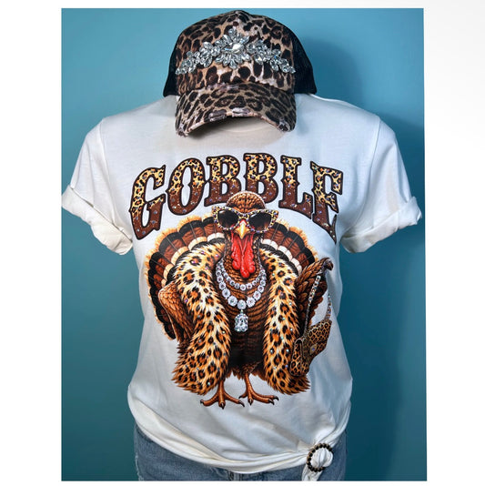 White Thanksgiving graphic tee featuring a glamorous leopard print turkey with sunglasses, jewelry and sparkling AB rhinestone embellishments

