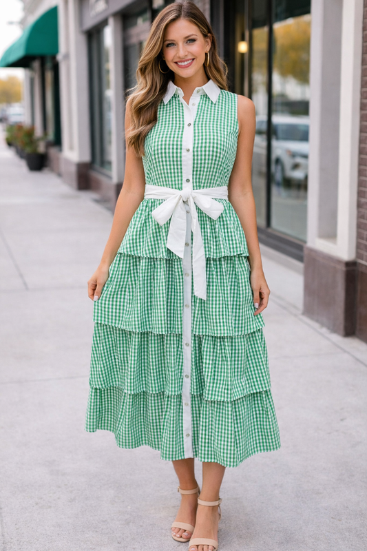Woman wearing green gingham tiered midi dress with white collar and tie waist