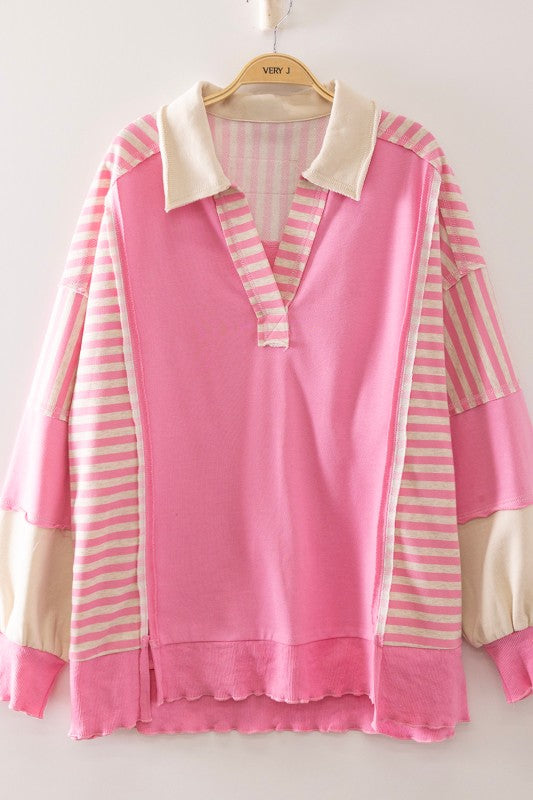 Pink and white striped shirt on a hanger against a white background