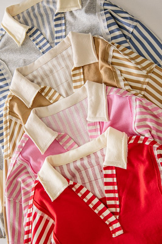 A close-up flat lay of striped collared shirts in multiple colors, including gray, blue, beige, pink, and red, arranged diagonally with cream-colored collars.