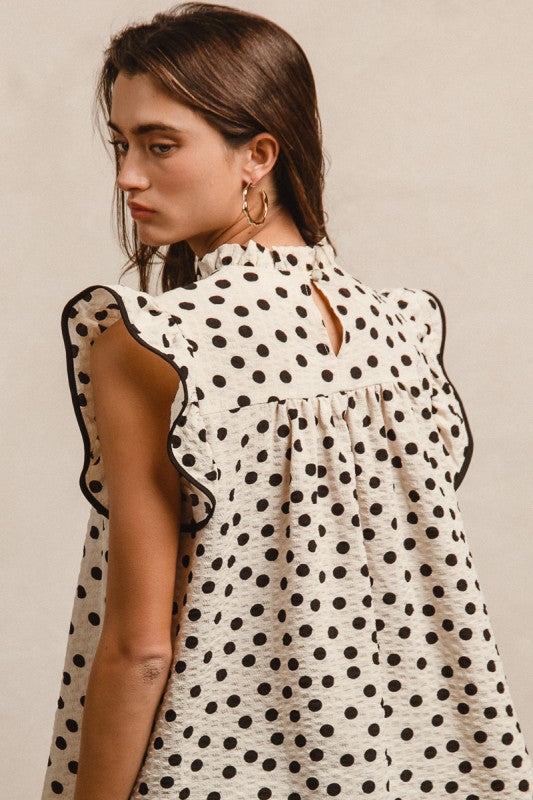 Oatmeal dot print smocked yoke top with ruffle detail and contrast binding
