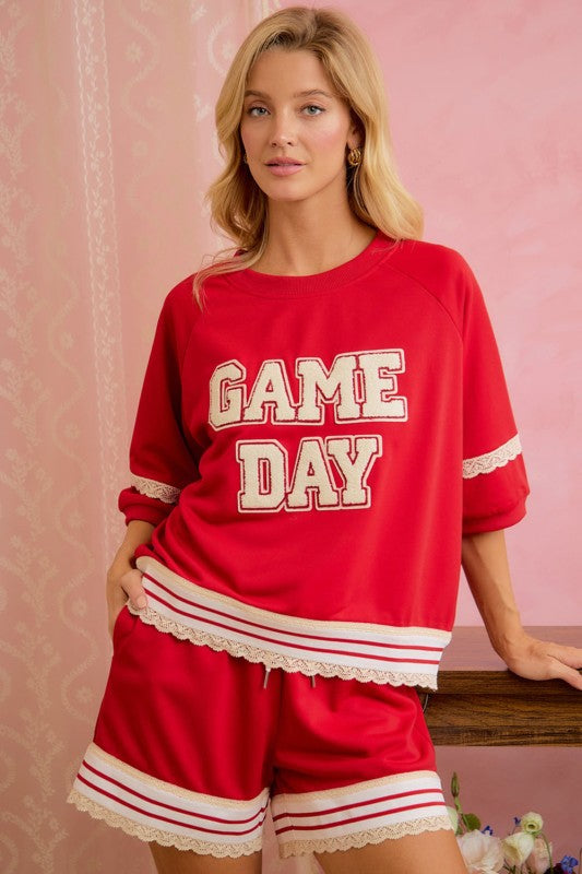 Women's red Game Day football top with varsity lettering and cream lace trim