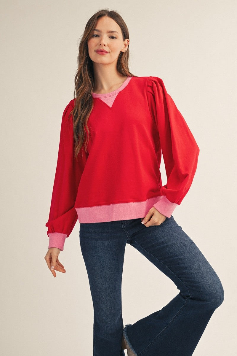 Women's red long sleeve puff shoulder top with pink contrast ribbed trim