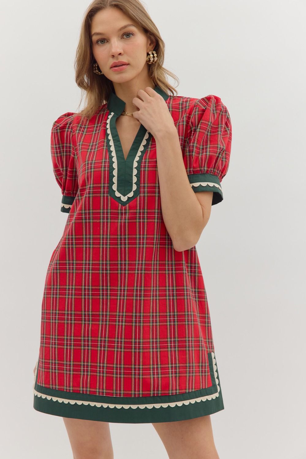 Red plaid dress with green accents worn by a model on a white background