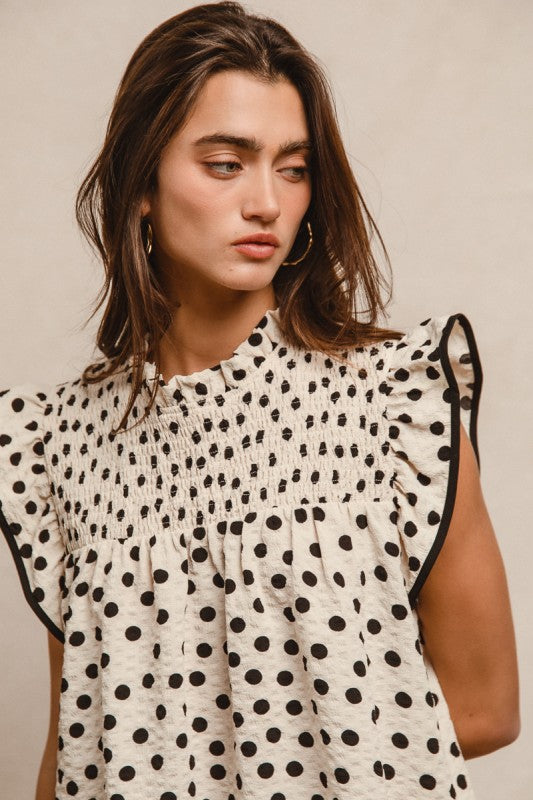 Oatmeal dot print smocked yoke top with ruffle detail and contrast bindinG