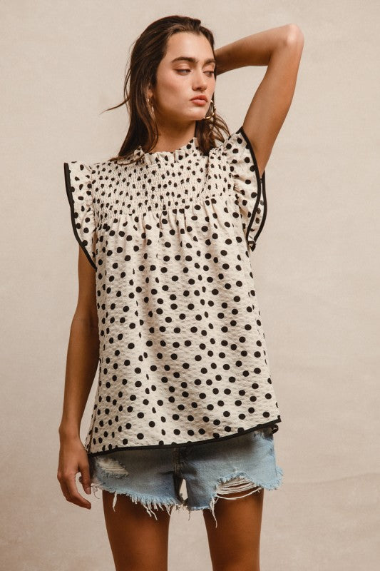 Oatmeal dot print smocked yoke top with ruffle detail and contrast binding
