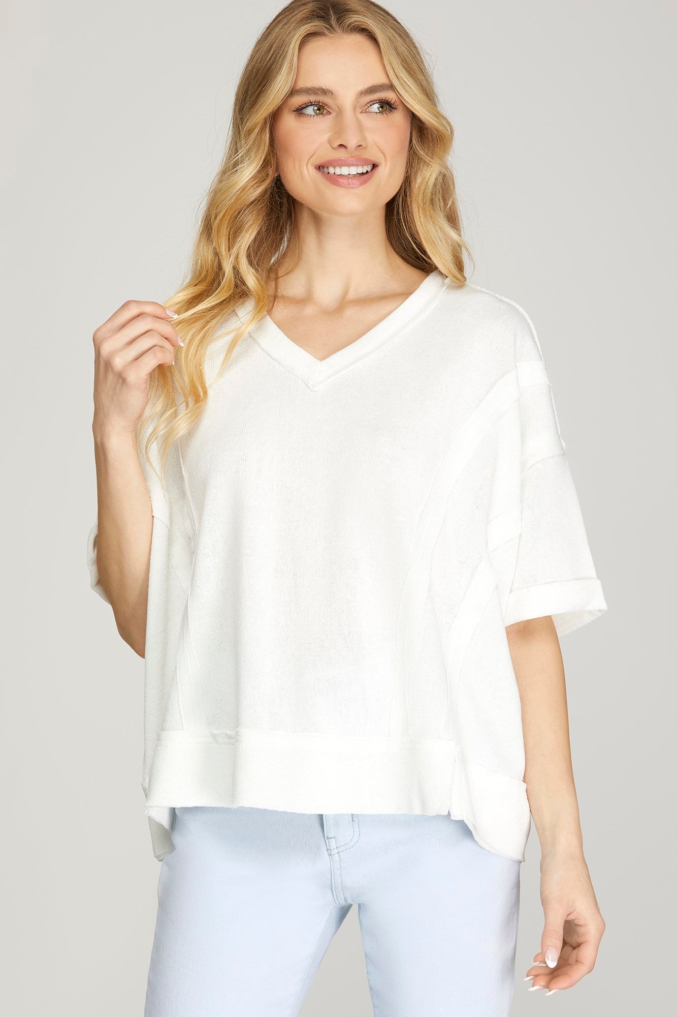 Women’s off white V-neck raw edge knit top from Twisted Sisters Shoetique in Waco Texas