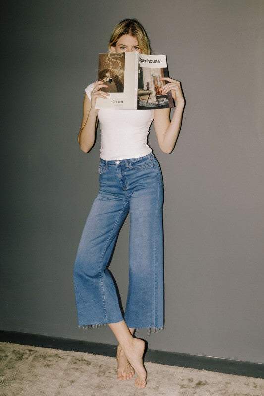 Vervet high rise medium wash cropped slim wide leg jeans with raw hem.