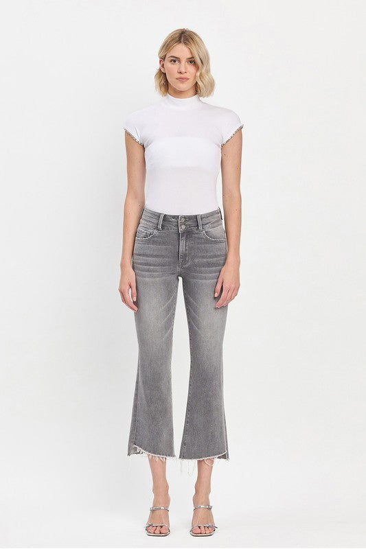 Model wearing Vervet by Flying Monkey Renato high-rise grey cropped mini bootcut jeans with raw slant hem.