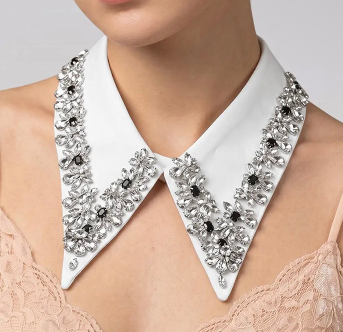 White detachable pointed collar necklace with clear crystal floral embellishments and black gemstone centers.